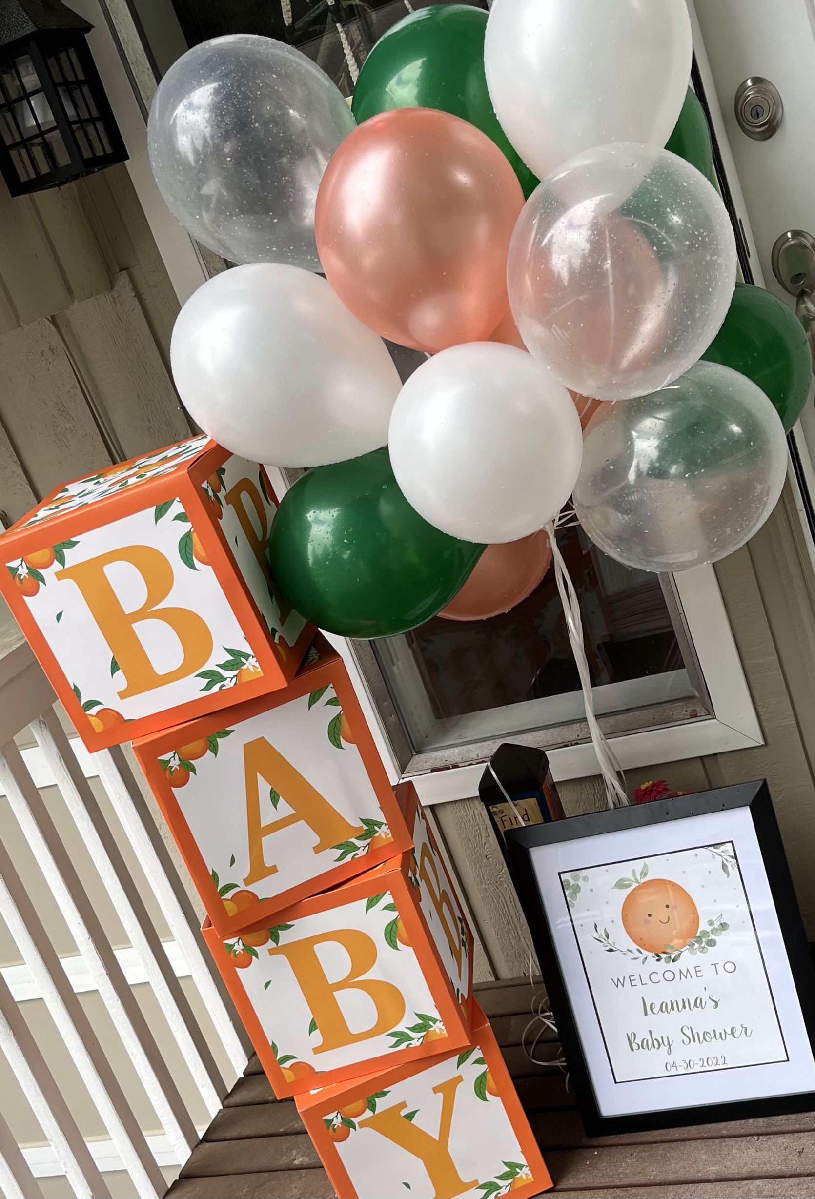 Baby shower setup with elegant floral and balloon arrangement